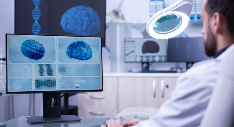 Young_medical_assistant_working_on_computer_in_a_hospital_laboratory._Brain_diagnosis._Young_medical_assistant_working_on_computer_in_a_hospital_laboratory._Brain_diagnosis.