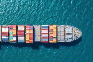 container_ship_in_import_export_and_business_logistic.By_crane_,Trade_Port_,_Shipping.cargo_to_harbor.Aerial_view.Water_transport.International.Shell_Marine.Top_view.