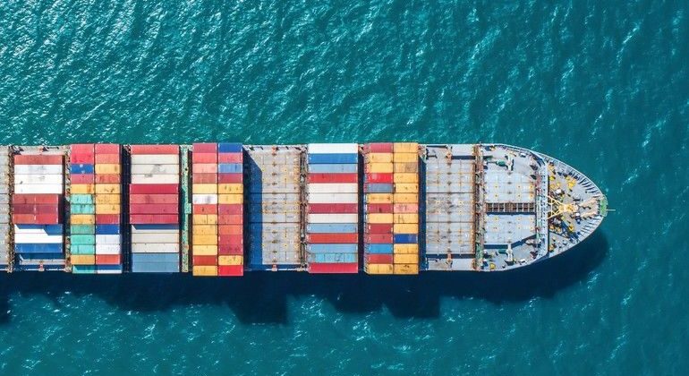 container_ship_in_import_export_and_business_logistic.By_crane_,Trade_Port_,_Shipping.cargo_to_harbor.Aerial_view.Water_transport.International.Shell_Marine.Top_view.