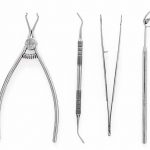 Set_of_dentists_tools_including_round_mirror_on_white_background_top_view.