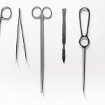 Medical_instruments_for_plastic_surgery_on_white_backgrond_top_view_copyspace.
