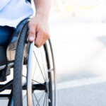 cropped_image_of_man_using_wheelchair_on_street