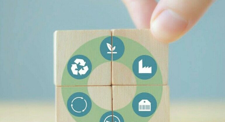 Circular_economy_concept_for_sustainable_development._Male_puts_wooden_cube_with_the_cycle_icon_of_natural_resource,_production,_product,_usage,_reuse_and_recycling_standing_with_grey_background._